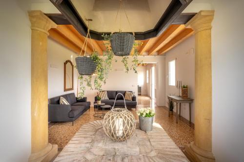 a living room with two couches and a table at Barchessa Cappelletto in Torre di Mosto