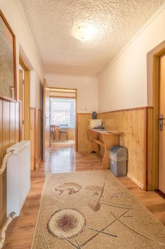 a living room with a desk and a table at Privát Marika in Ždiar