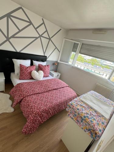 a bedroom with a bed and a large window at Appartement proche de La Défense in Puteaux