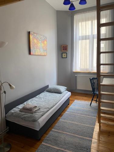 a bedroom with a bed in a room at Apartament Kamienica Centrum in Kętrzyn