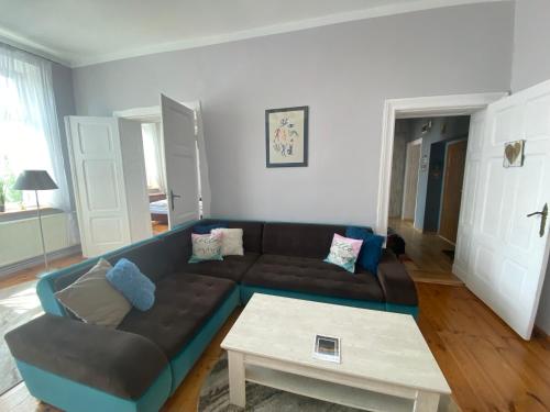a living room with a couch and a coffee table at Apartament Kamienica Centrum in Kętrzyn