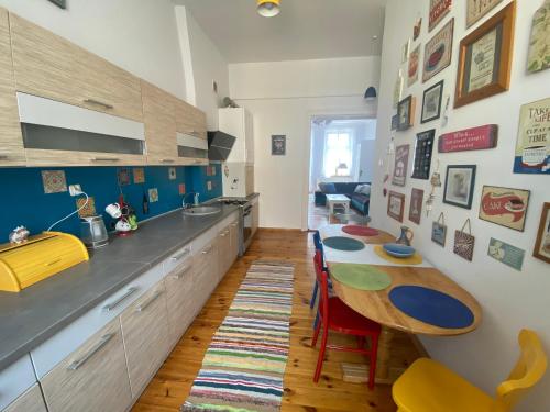 a kitchen with a counter and a table in a room at Apartament Kamienica Centrum in Kętrzyn