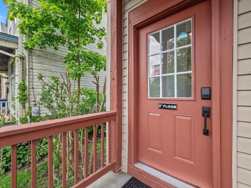 a red door on a house with a porch at Shadyside, Central 3C Spacious & Modern Private Bedroom With Shared Bathroom and Free Parking in Pittsburgh