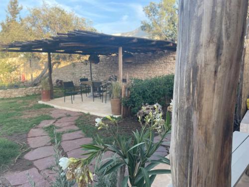 a patio with an umbrella and a table and chairs at TARGANINE Lodge in Essaouira