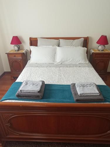 a bed with two towels on top of it at CASA SENHORA DA VEIGA in Vila Nova de Foz Coa