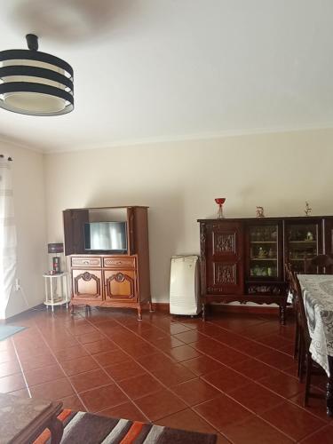 a living room with a tv and some furniture at CASA SENHORA DA VEIGA in Vila Nova de Foz Coa