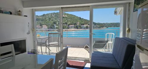 a room with a balcony with a view of the water at Villa Stegic in Tisno