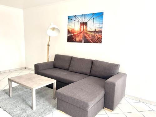 a living room with a couch and a table at M037 Marquer Joli T2 in Ambilly