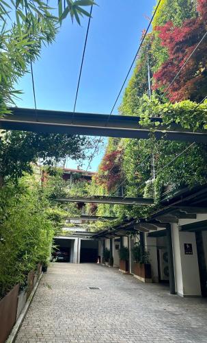 a walkway in a building with trees and a bridge at Residence Casa Coppa Appartamento Duplex in Omegna