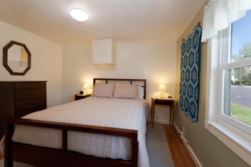 a bedroom with a bed and a window at Downtown Cottage in Durango