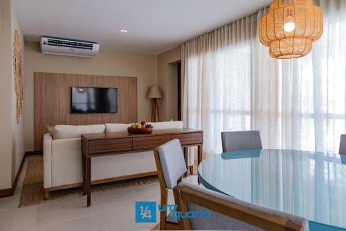 a living room with a table and a couch at Ponta de Inhambupe Residences in Baixio