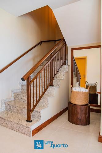 a staircase in a home with a wooden stair case at Ponta de Inhambupe Residences in Baixio