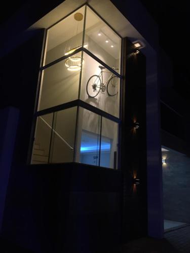 a view of a window with a bike in it at Casa da bike Balneario Gaivota 150 mt do mar in Balneário Gaivotas