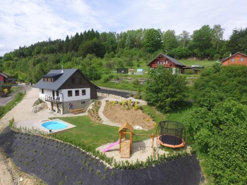 an aerial view of a house with a playground at Chalupa Jizerka in Plavy