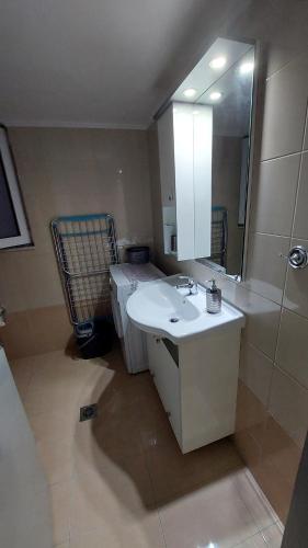 a bathroom with a sink and a mirror at George & Chrysi Apart in Kremasti
