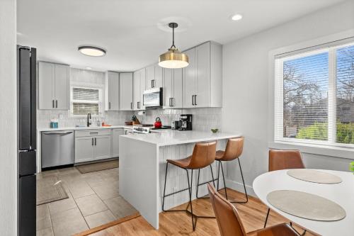 a kitchen with white cabinets and a table and chairs at 6224 S Datura St in Littleton