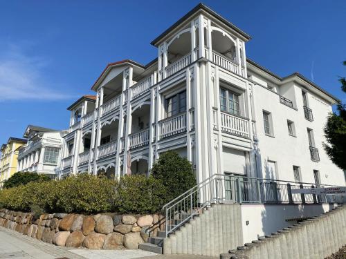 a large white building with a staircase in front of it at Villa Annika - Whg 06 in Ostseebad Sellin