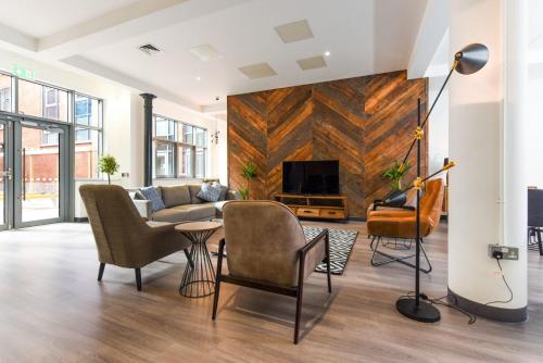 a living room with a couch and a tv at Student-Only Accommodations in Belfast in Belfast