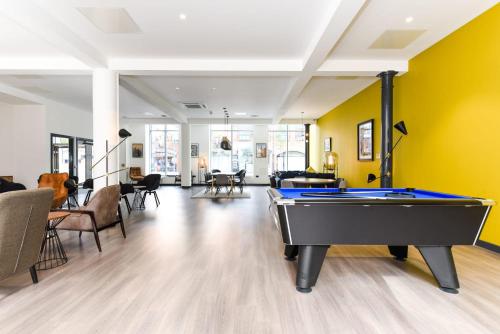 a pool table in a living room with yellow walls at Student-Only Accommodations in Belfast in Belfast