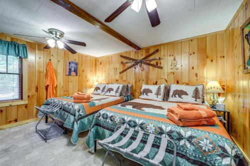 a bedroom with two beds and a ceiling fan at Pet-Friendly Maggie Valley Cabin with Pool Access! in Maggie Valley