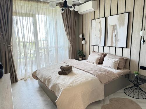 a bedroom with a large bed with a suitcase on it at Kristin`s Home in Burgas