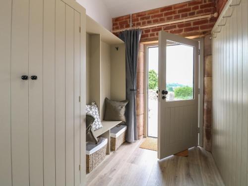 a hallway with a door leading to a balcony at Alder Cottage - Fold Yards in Belper