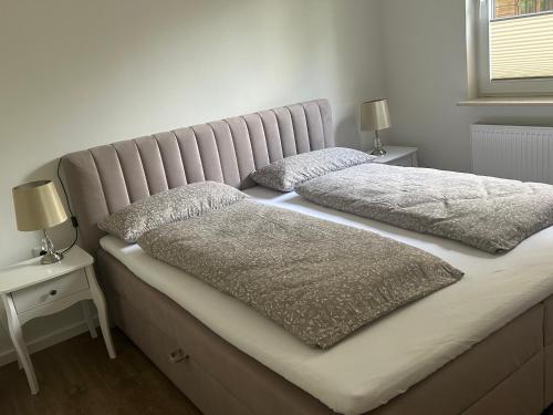 a bed with two pillows on it in a bedroom at Lilli Flensburg Fewo in Flensburg