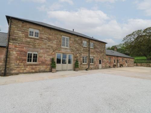a large brick building with a driveway in front of it at Rowan Cottage - Fold Yards in Belper