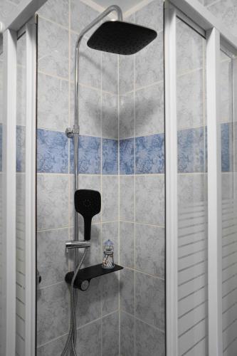 a shower with a black shower head in a bathroom at Apartman Mare in Dramalj