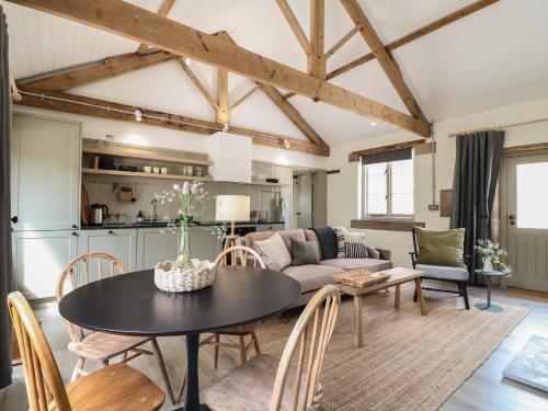 a living room with a table and a couch at Oak Cottage - Fold Yards in Belper