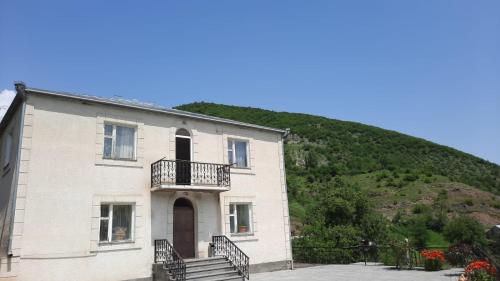 a large building with a hill in the background at Гандзакар in Ijevan