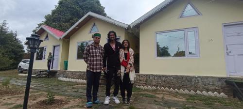 a group of people standing in front of a house at THE HIDEAWAY Homestay Chail in Chail