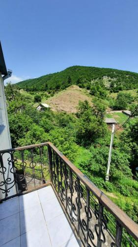 a balcony with a view of a hill at Гандзакар in Ijevan