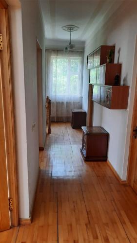 a living room with a wooden floor and a window at Гандзакар in Ijevan