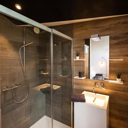 a bathroom with two sinks and a shower at dimensions M in Mont-Saint-Guibert