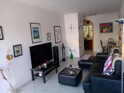 a living room with two couches and a flat screen tv at Christian in Cruce de Arinaga