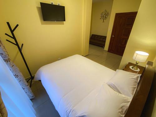 Postel nebo postele na pokoji v ubytování Gran Hotel REX