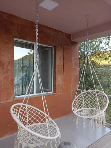 two swings hanging from the porch of a house at Green Garden in Ijevan