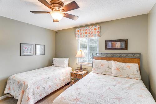 a bedroom with two beds and a ceiling fan at St Simons Condo with Resort Amenities 1 Mi to Beach in Mallory Park