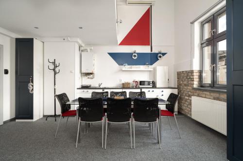 a kitchen with a dining table and black chairs at Sleepway Apartment - Marina in Poznań