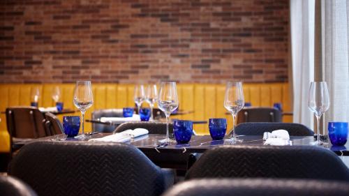 a set of tables with wine glasses on them at Tŷ Newport in Newport