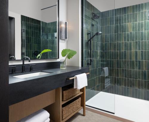 a bathroom with a sink and a shower at Kimpton Santo, an IHG Hotel in San Antonio