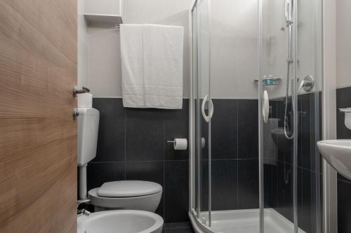 a bathroom with a toilet and a glass shower at Hotel Delle Nazioni - Adults Only in Caorle