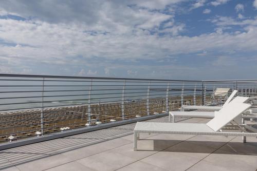 a balcony with a bench and the ocean at Hotel Delle Nazioni - Adults Only in Caorle