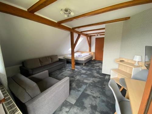 a living room with a couch and a bed at Pod Orlicą in Duszniki Zdrój