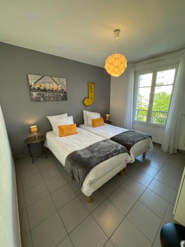 a bedroom with a large bed and a window at Dream Apartments in Serris
