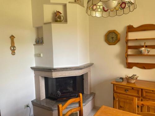 a living room with a fireplace and a wooden table at Casa Isa in Narni Scalo
