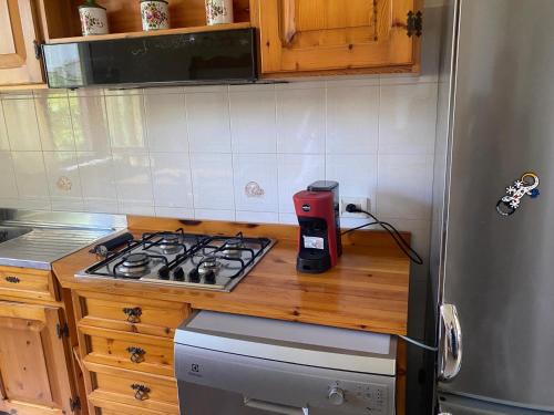 a kitchen with a counter with a stove top oven at Casa Isa in Narni Scalo
