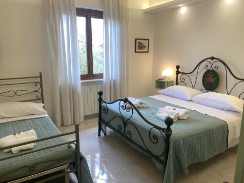 a bedroom with two beds with towels on them at Casa Isa in Narni Scalo