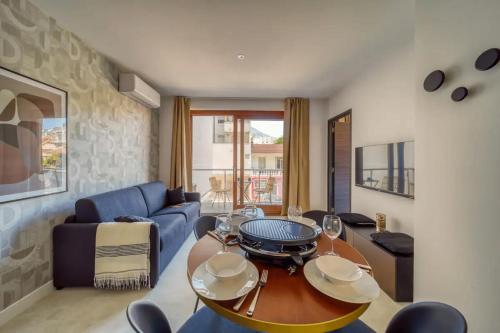 un salon avec une table et un canapé bleu dans l'établissement #GT Le Joli Berthelot, à Grenoble